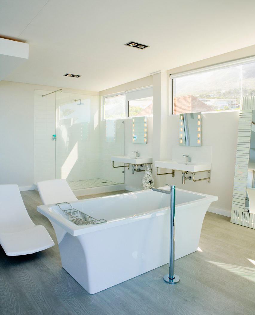 Clean modern bathroom with freestanding tub — fixture and finish plumbing by Galli Plumbing Services