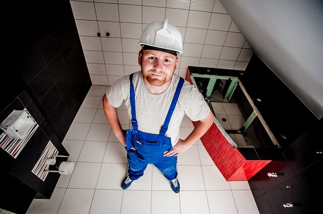 Professional plumber working on water heater installation
